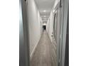 Long hallway with tile flooring leading to various rooms at 649 Lincoln St, Kissimmee, FL 34741