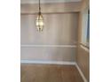 Simple dining area with tile flooring and a light fixture at 3701 Castle Pines Ln # 3914, Orlando, FL 32839
