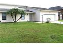 House exterior with a one car garage and grassy yard at 348 Jacksonville Ct, Kissimmee, FL 34759