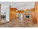 Large living room with vaulted ceilings, tile floors, and a brick fireplace at 4147 Boggy Creek Rd, Kissimmee, FL 34744