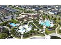 Community clubhouse and resort-style pool with surrounding homes at 1612 Herrons Green Path, Kissimmee, FL 34747
