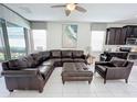 Open concept Gathering room with a sectional sofa and access to the backyard at 1612 Herrons Green Path, Kissimmee, FL 34747