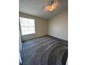 Simple bedroom with carpet and a window at 1916 Lake Atriums Cir # 46, Orlando, FL 32839