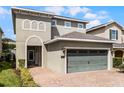 Two-story house with a two-car garage and landscaped front yard at 280 Pendant Ct, Kissimmee, FL 34747
