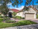 Single-story home with red tile roof, neutral exterior, and landscaped front yard at 722 Coronado Dr, Kissimmee, FL 34759