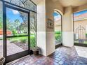 Bright and airy enclosed porch with brick flooring and views of the surrounding area at 722 Coronado Dr, Kissimmee, FL 34759