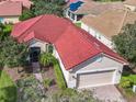 Aerial view shows the home's red tile roof and location within the community at 722 Coronado Dr, Kissimmee, FL 34759