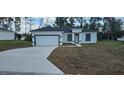 Newly built one-story house with attached garage and driveway at 2648 Sw 146 Th Place Rd, Ocala, FL 34473