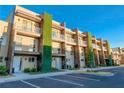 Modern townhome building with parking lot and landscaping at 3213 Brasilia Ave, Kissimmee, FL 34747