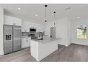 Modern kitchen with island, stainless steel appliances, and white cabinets at 2396 Sw 147Th Lane Rd, Ocala, FL 34473