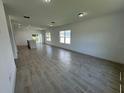 Open concept living room and kitchen with tile floors and lots of natural light at 1204 Vero Beach Way, Poinciana, FL 34759
