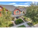 Two-story townhome, gray roof, red accents, landscaped yard, and walkway at 2917 Windmill Dr, Kissimmee, FL 34741