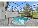 Inviting screened pool with paver deck and lush landscaping at 274 Captiva Dr, Davenport, FL 33896