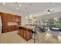Spacious kitchen with granite island, stainless steel appliances, and dark wood cabinets at 274 Captiva Dr, Davenport, FL 33896