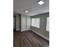Spacious bedroom with wood-look flooring and large windows at 5819 Colchester Dr, Orlando, FL 32812