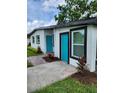 Newly renovated home with teal doors and white exterior at 5819 Colchester Dr, Orlando, FL 32812