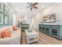 Bright living room features comfy sofas, a large TV, and stylish coffee table at 3037 Sea Plane Ln, Kissimmee, FL 34747