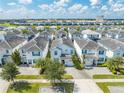 Aerial view of a community with multiple two-story houses at 4722 Sleepy Hollow Dr, Kissimmee, FL 34746