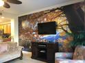 Living room features a scenic wall mural and comfy seating at 13415 Blue Heron Beach Dr # 304, Orlando, FL 32821