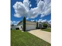 House exterior showcasing a two-car garage and driveway at 1837 Hickory Bluff Rd, Kissimmee, FL 34744