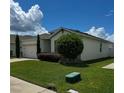Single-story house with a two-car garage and well-maintained lawn at 1837 Hickory Bluff Rd, Kissimmee, FL 34744