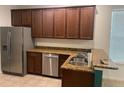 Kitchen with stainless steel appliances and dark brown cabinets at 10710 Reams Rd, Windermere, FL 34786