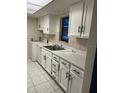 Efficient kitchen with white cabinets and tiled floor at 2616 Lemon Tree Ln # F, Orlando, FL 32839