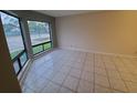 Bright living room with tile flooring and large windows at 2616 Lemon Tree Ln # F, Orlando, FL 32839