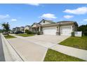 Two-story house with two-car garage and manicured lawn at 2921 Hooded Crane Cv, Harmony, FL 34773