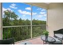 Screened balcony overlooking lush trees and a scenic view at 2300 Silver Palm Dr # 303, Kissimmee, FL 34747