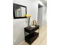 Entryway with a dark wood console table and mirror at 4738 Blue Diamond St, Kissimmee, FL 34746