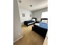 Bedroom with two twin beds, nightstands, and wall art at 4738 Blue Diamond St, Kissimmee, FL 34746