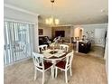 Bright dining area with a table and chairs, adjacent to kitchen at 3073 Royal Tern Dr, Winter Haven, FL 33881