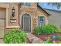 Inviting front entry with stone accents and a screen door at 356 Toldedo Rd, Davenport, FL 33837