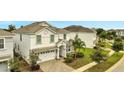 Two-story house with white exterior and a two-car garage at 8839 Interlocking Ct, Davenport, FL 33896