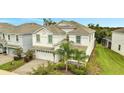 Two-story house with white exterior and a two-car garage at 8839 Interlocking Ct, Davenport, FL 33896