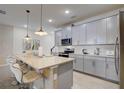 Modern kitchen with gray cabinets, stainless steel appliances, and an island at 1842 Tropical Palms Cir, Kissimmee, FL 34747