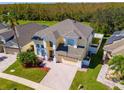 Two-story house with a large driveway and nicely landscaped yard at 1740 N Hampton Dr, Davenport, FL 33897