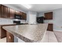 Modern kitchen with dark brown cabinets, granite counters, and island at 816 William Way, Haines City, FL 33844