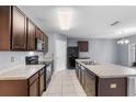Modern kitchen featuring dark brown cabinets and a kitchen island at 816 William Way, Haines City, FL 33844