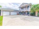 Two-story house with double garage, covered porch, and well-maintained landscaping at 1380 E Lake Shore Blvd, Kissimmee, FL 34744