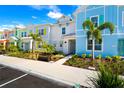 Row of colorful townhouses with landscaping at 2980 On The Rocks Pt, Kissimmee, FL 34747