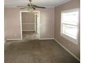 Bright living room with carpet flooring and ceiling fan at 896 N 9Th St, Eagle Lake, FL 33839