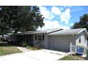 Updated ranch home with grey siding, mature trees, and a fenced yard at 896 N 9Th St, Eagle Lake, FL 33839