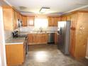 Updated kitchen with light wood cabinets, granite countertops, and stainless steel appliances at 896 N 9Th St, Eagle Lake, FL 33839