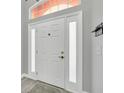 Bright entryway with a neutral color palette and modern door at 621 Knightsbridge Cir, Davenport, FL 33896