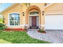 Brick walkway leading to a charming front door at 621 Knightsbridge Cir, Davenport, FL 33896