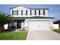 Two-story home with gray siding, black shutters, and a two-car garage at 1816 Stargazer Trl, Kissimmee, FL 34758