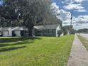 Gray house with a large front yard and sidewalk at 3000 Cashmere Dr, Orlando, FL 32827