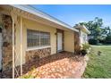 House exterior with stone, tile, and landscaping at 402 Tuscarora St, Lakeland, FL 33805